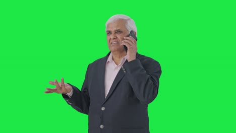 Indian-senior-manager-talking-on-phone-Green-screen