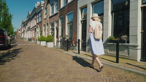 Young-Woman-With-Smartphone-Walking