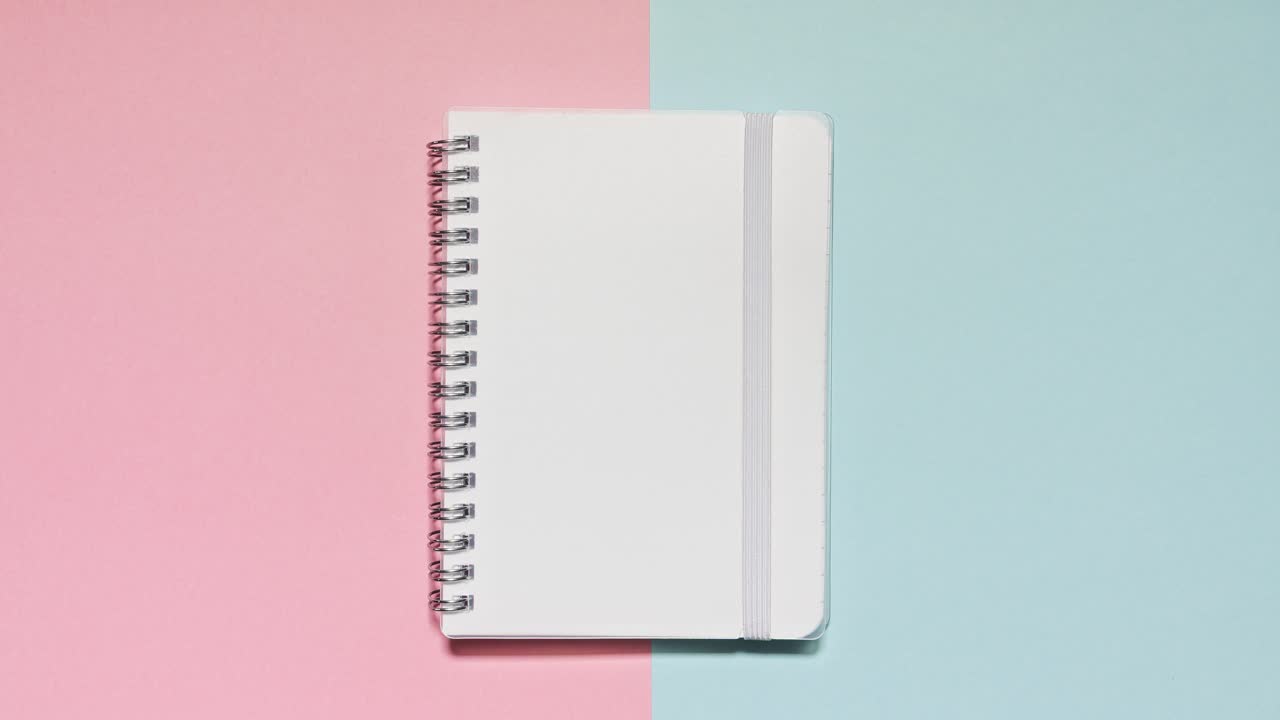 Stop motion notebook opens on a pink and blue split set with matching stationery