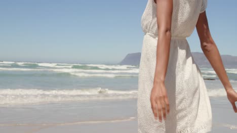 low angle view of young african american woman having fun on beach in the sunshine 4k