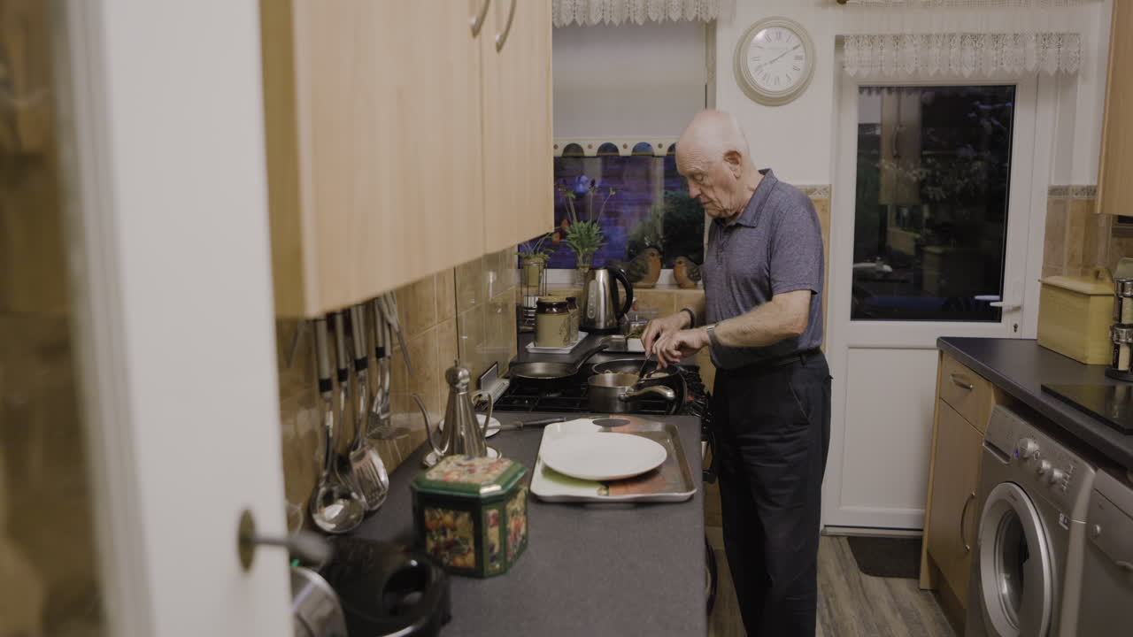 An elderly man is cooking in the kitchen
