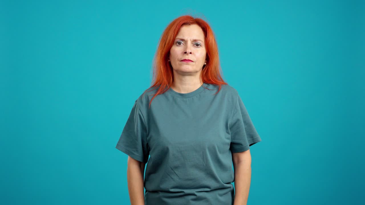Middle-aged woman with red hair looking tired or sad with closed eyes