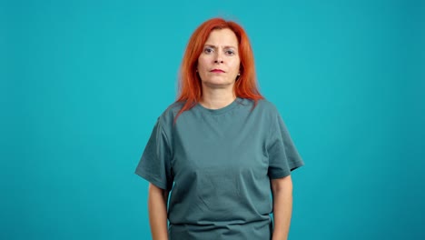 middle-aged woman with red hair looking tired or sad with closed eyes