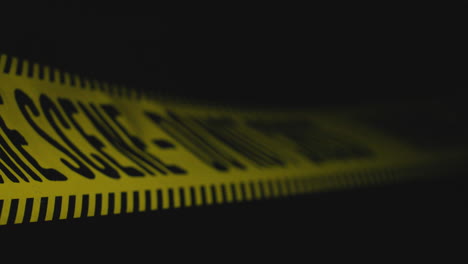 close-up of crime scene tape at night