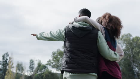 camping, couple and rear view of hand pointing to