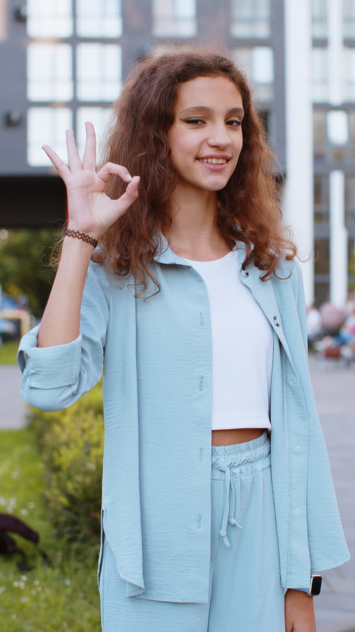 Happy cheerful child girl showing ok gesture positive like sign approve something good celebrate