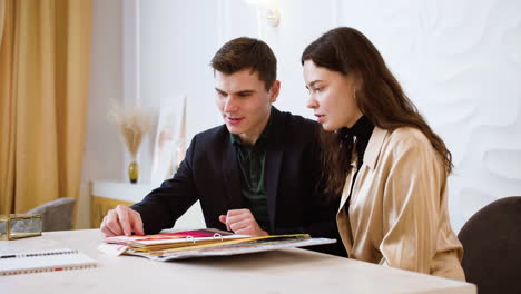 couple sitting in wedding planner office