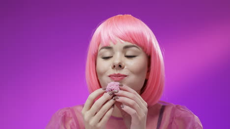 Close-Up-Of-Cute-Woman-Wearing-A-Pink-Wig-And-Eating-Pink-Marshmallow