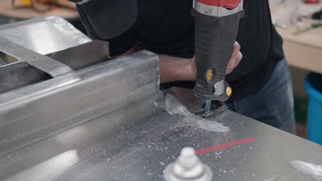 man's hands sawing with reciprocating saw - close-up