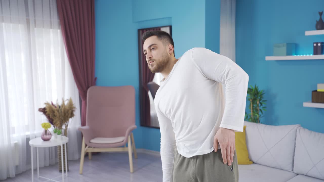 Sporty young man working out his body by exercising alone at home.