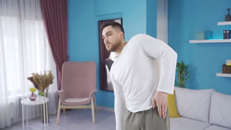 sporty young man working out his body by exercising alone at home.