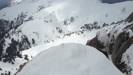 Lone-sign-atop-Tigaile-Mari-peak-with-panoramic-snowy-mountain-view,-cloudy-day