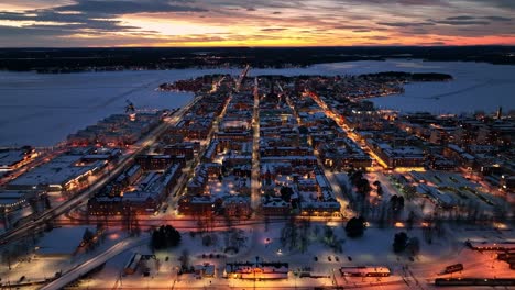 luleå city at dusk with street lights and snow-covered landscape, aerial, aerial view