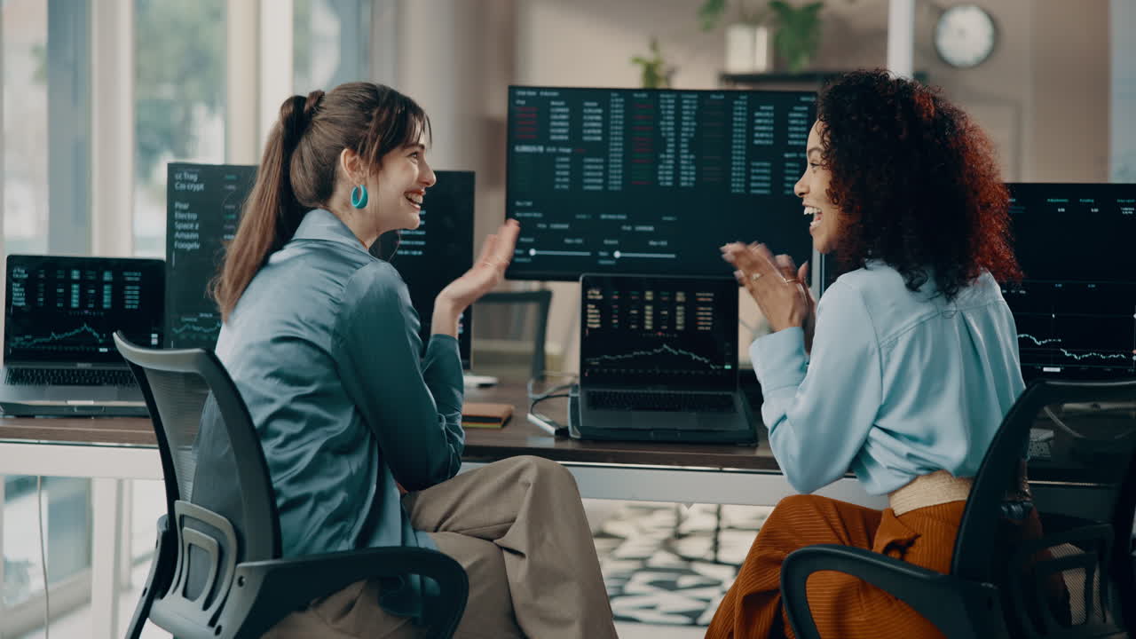 Two Businesswomen Celebrating Stock Market Success in Office