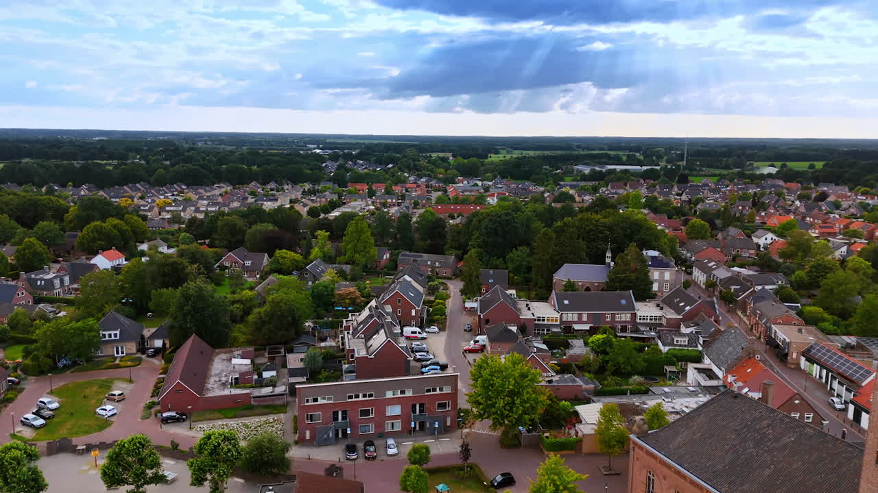 Sunlit village with central tower. A drone view shows the center of a small Dutch town with a tower on the main square