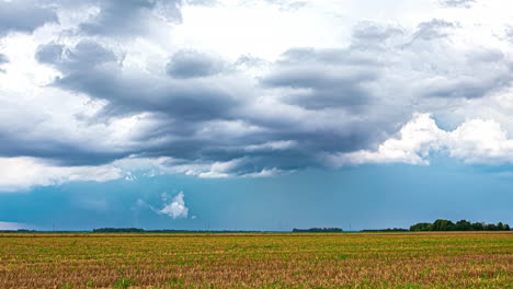 A-Time-Lapse-Shot-Of-A-Wind-Shear-And-A-Field-Landscape-With-A-Forest-Line