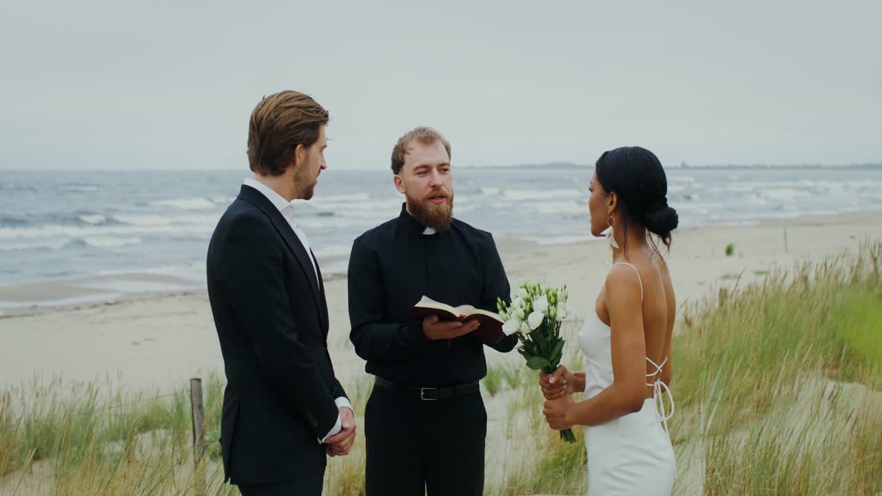 Beach Wedding Ceremony with Bride, Groom, and Officiant