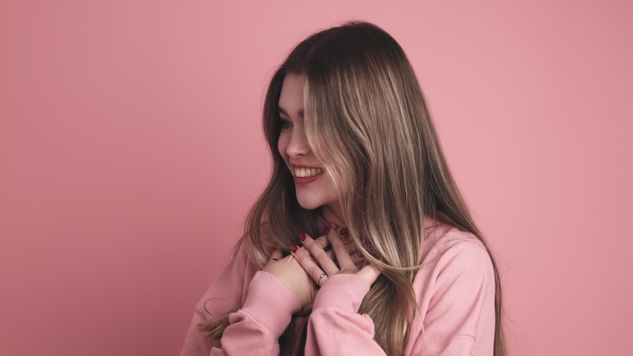 Cheerful thrilled young woman standing in room