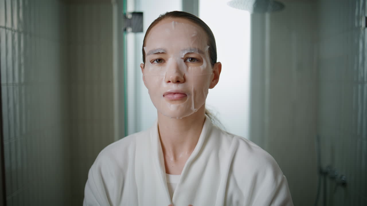 Beauty model put mask on face closeup. Hydrating skincare routine in morning