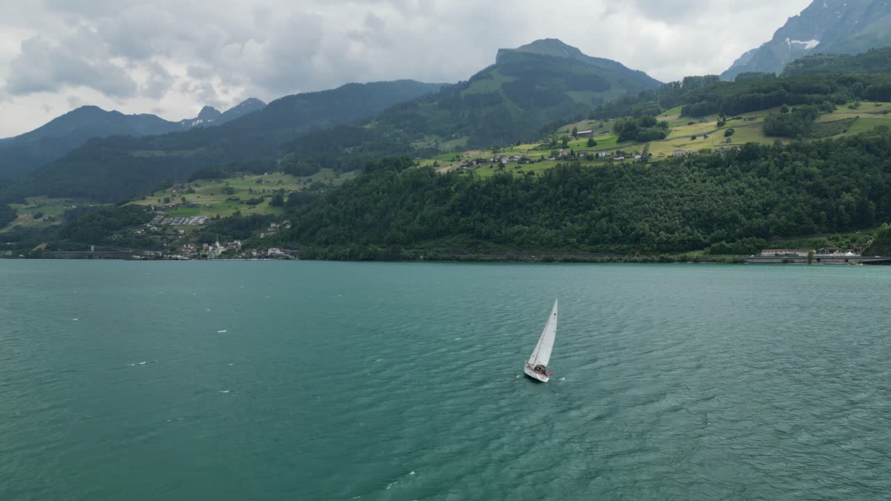 hermoso yate navegando en las aguas tranquilas del lago con un telón de fondo montañoso