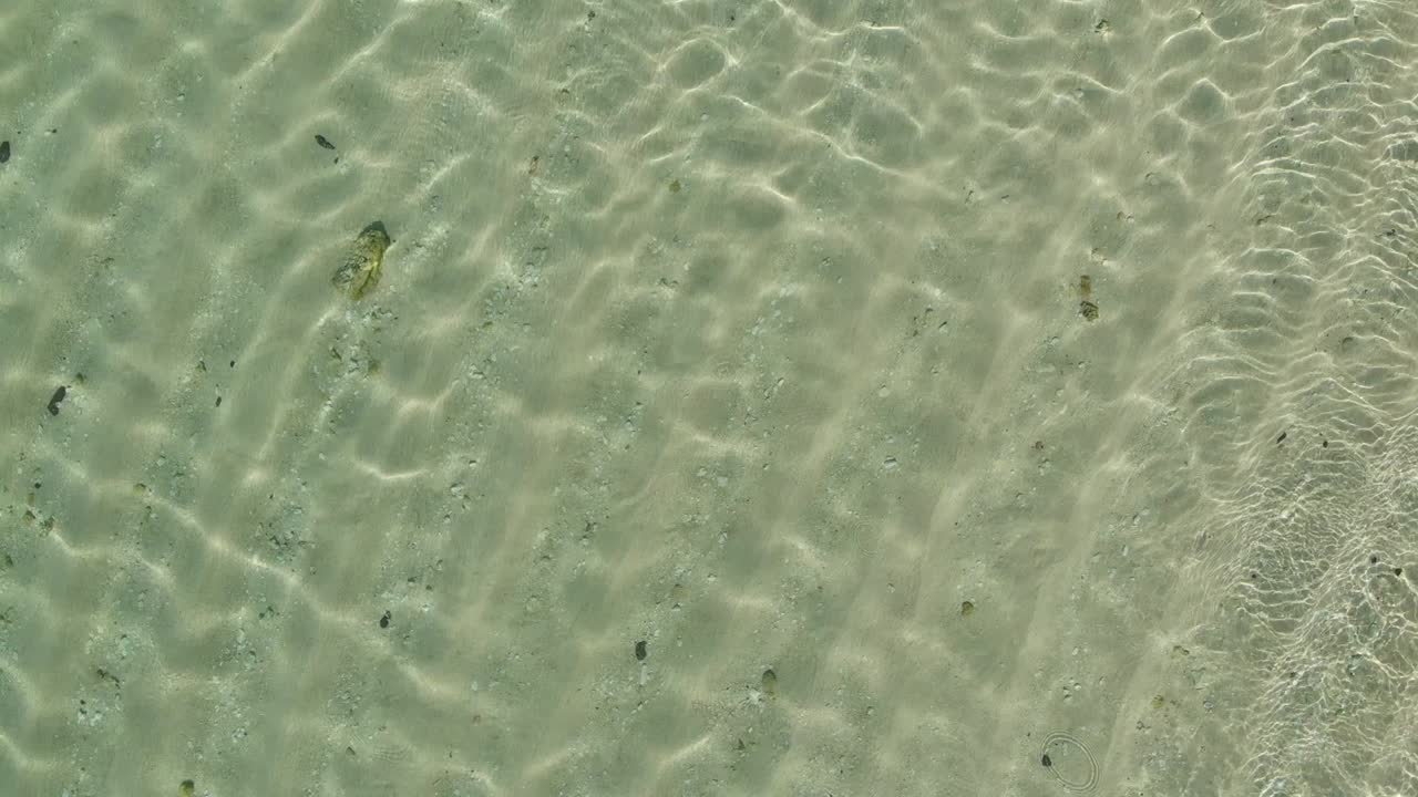 Aerial Drone top down View of green sea water texture. 4K Background of Azure ocean crystal clear water with ripple on surface.