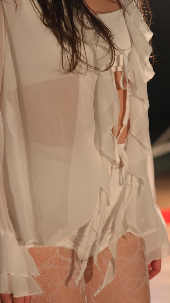 Woman Kneeling in White Clothing and Lace Tights