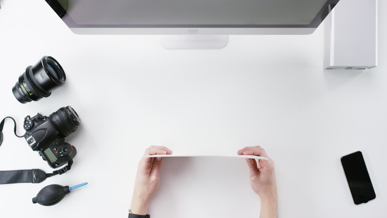 Top view photographer graphic designer chosing beauty images working at desk from above - Red Epic Dragon