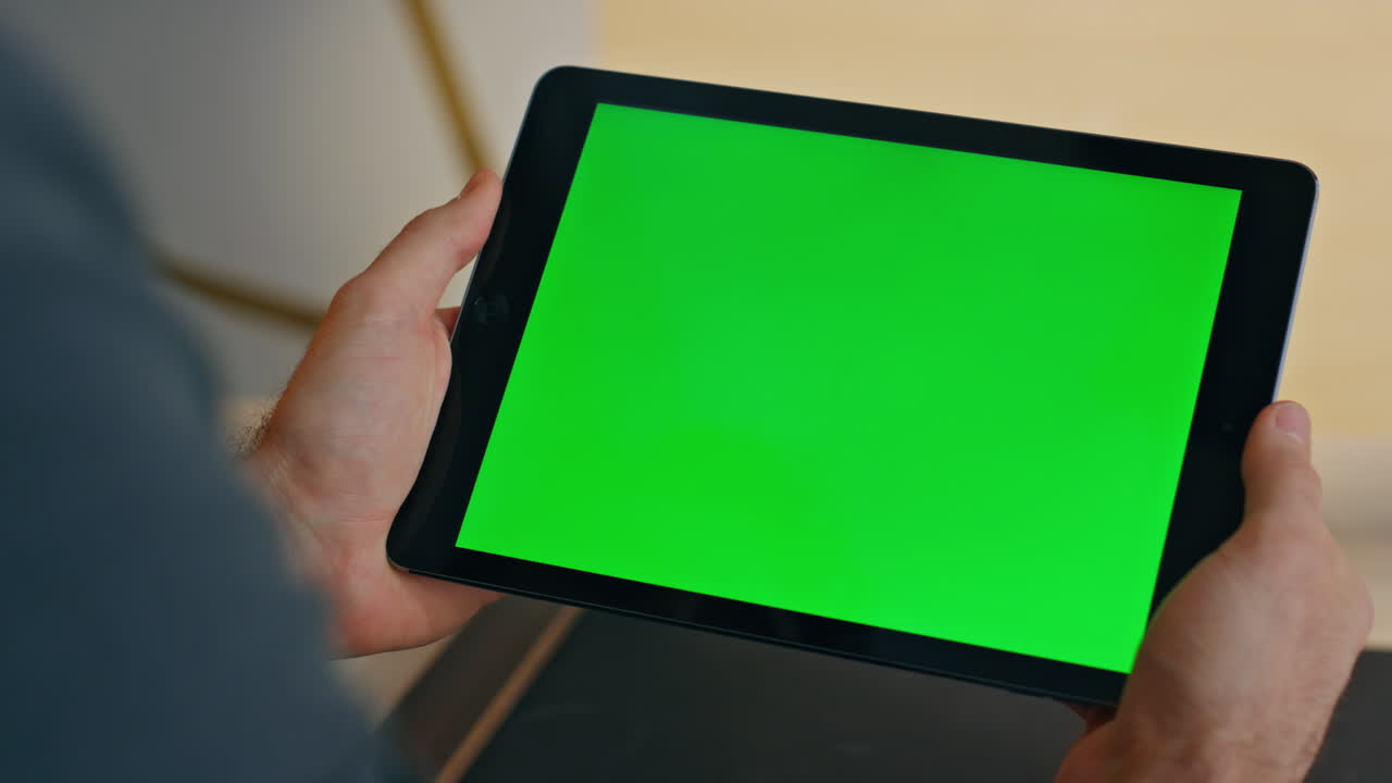 Freelancer hands holding greenscreen tablet working remote at office closeup
