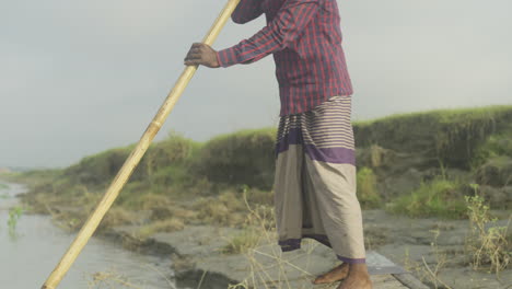 boatman puhing with oars in the river with maximum effort