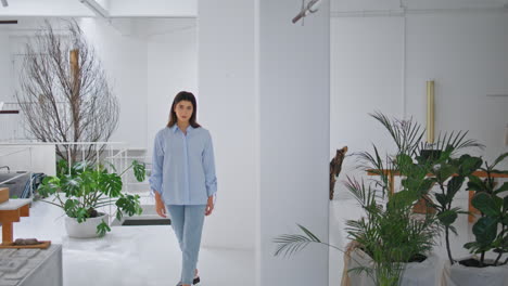 beautiful girl stepping apartment room. young designer posing in store studio