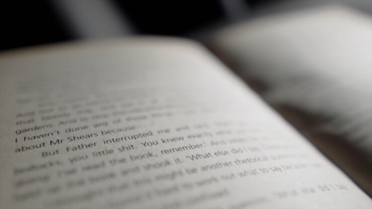 visual representation of attention gradually diminishing as book page with the top of the page in focus, gradually becoming blurry as camera moves down the page