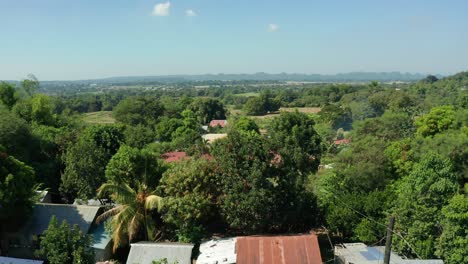 Ascending-Aerial-View-of-a-Small-Village-surrounded-by-Farm-Lands-and-Trees-in-the-Philippines-in-4K