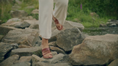 footsteps crossing river mountains