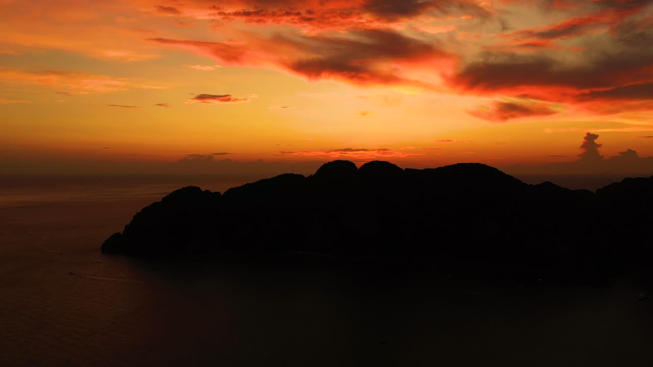 Amazing colorful sunset behind an island. Ko Phi Phi Thailand at dusk. Aerial