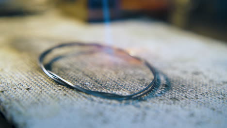 heating gold rod with gas burner in jewelry shop closeup