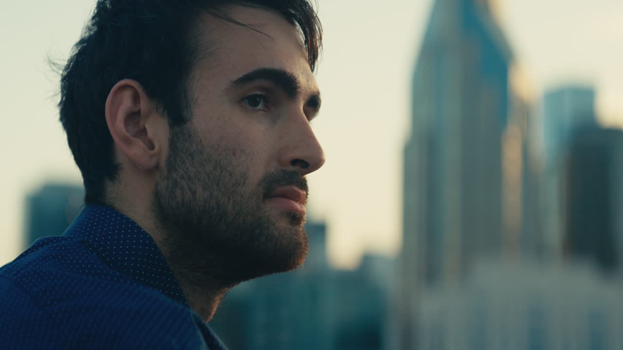 Man on a rooftop overlooking a city