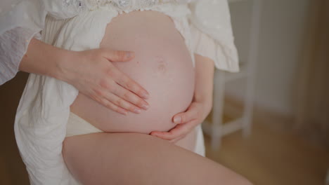 pregnant woman cuddling belly