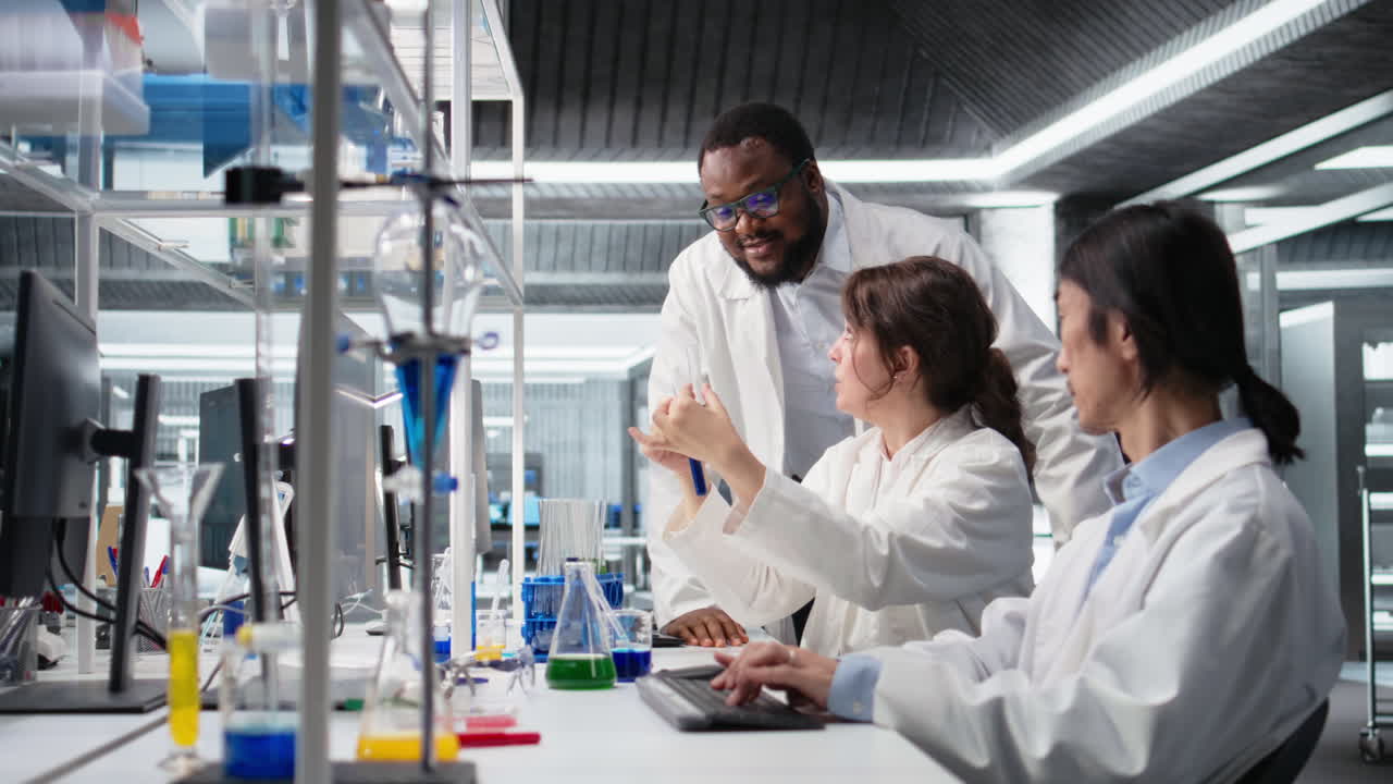 Vertical video Multiethnic chemical engineers using laboratory glassware with solution