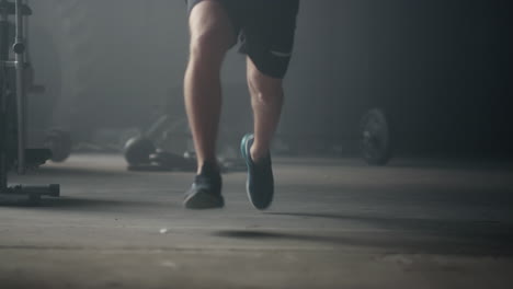 fitness man standing on start position. male jogger legs running in sport club