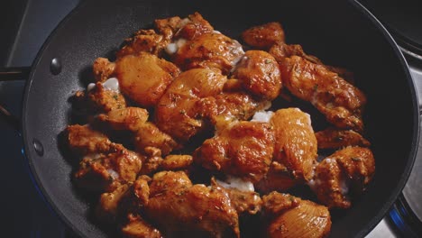 spicy chicken breast fillet cooking in a pan