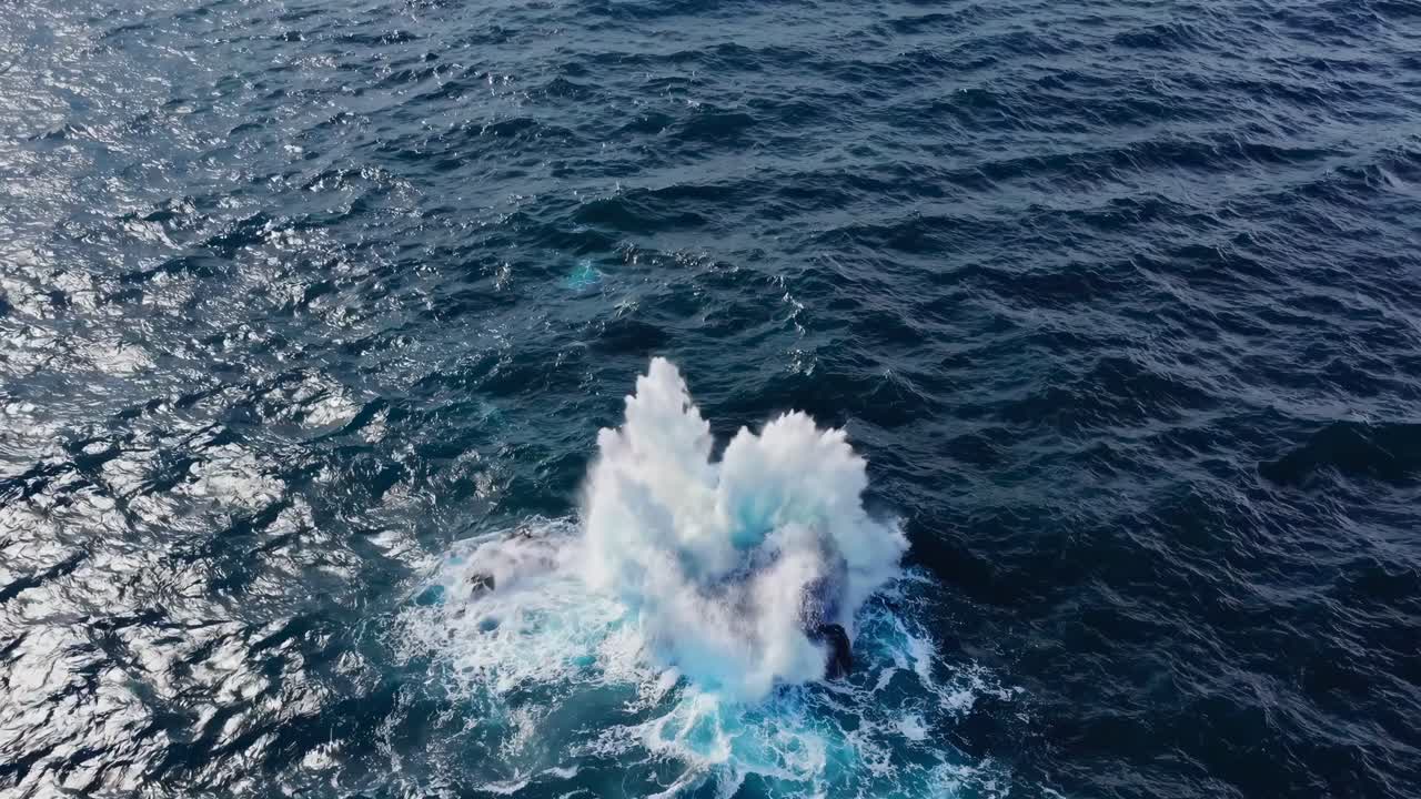 Aerial video captures a dramatic ocean splash, showcasing powerful waves from a high angle