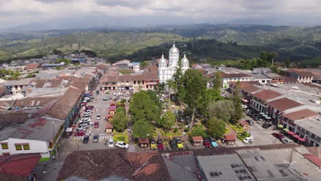 Colonial-style-Bolívar-Park-in-Filandia-Quindio,-Colombia,-aerial-orbit-daytime