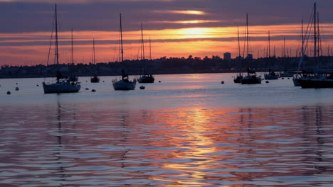 sunset over a marina with sailboats