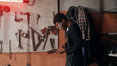 man using tablet in a workshop