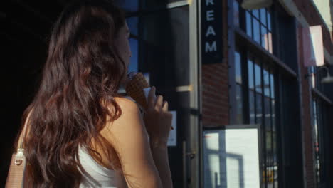 tranquil girl going with ice cream closeup. asian woman licking dessert on walk.