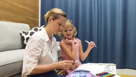 mother and daughter doing homework together at home