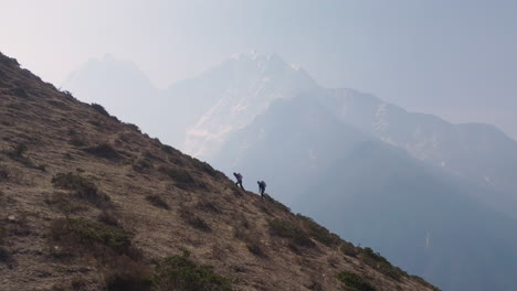 drone view from phortse to dingboche, layered hills and hidden mountain range under cloudy skies, tourists trekking scenic everest route nepal tourism experience