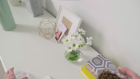 person handling tea leaves in home office