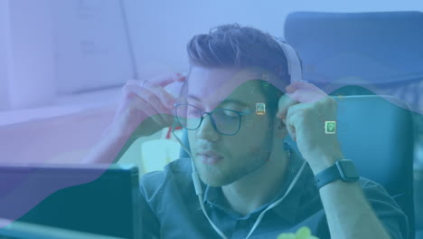 animation of network of connections and media icons over businessman at desk using computer
