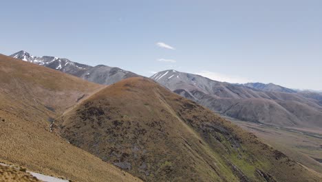 dry canterbury foothills in front of southern alps with residual snow during sunny spring day